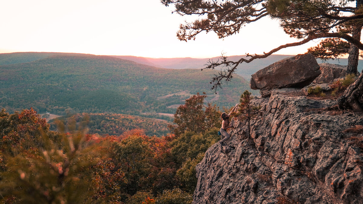 Josh rock climbing at sunset